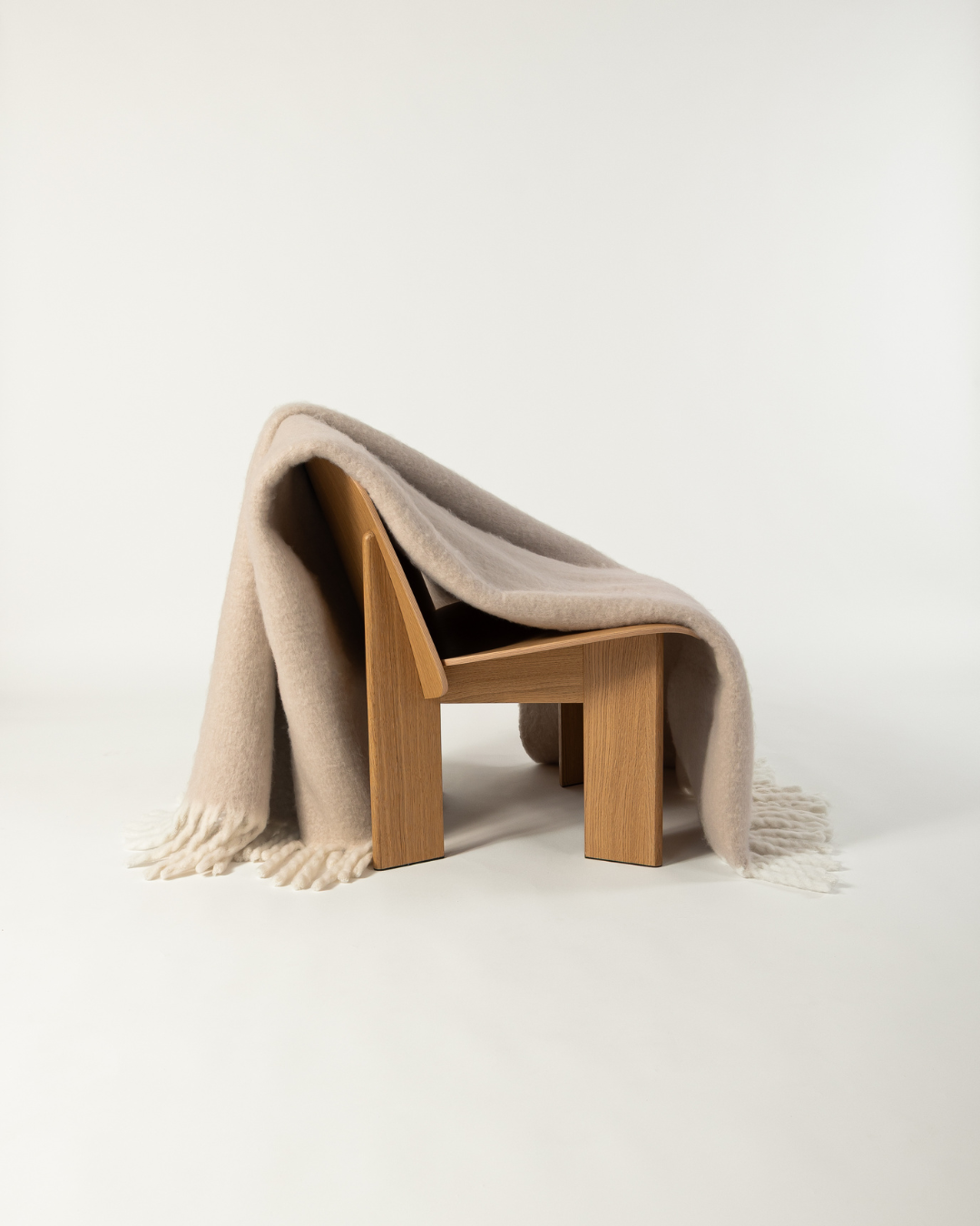Faux Mohair Blanket in Clay/Moon draped over wooden chair