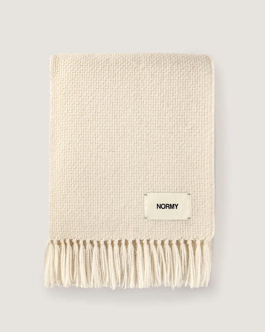 Normy Alpaca Blanket in moon with a small cream label reading NORMY, shown on a light gray background.