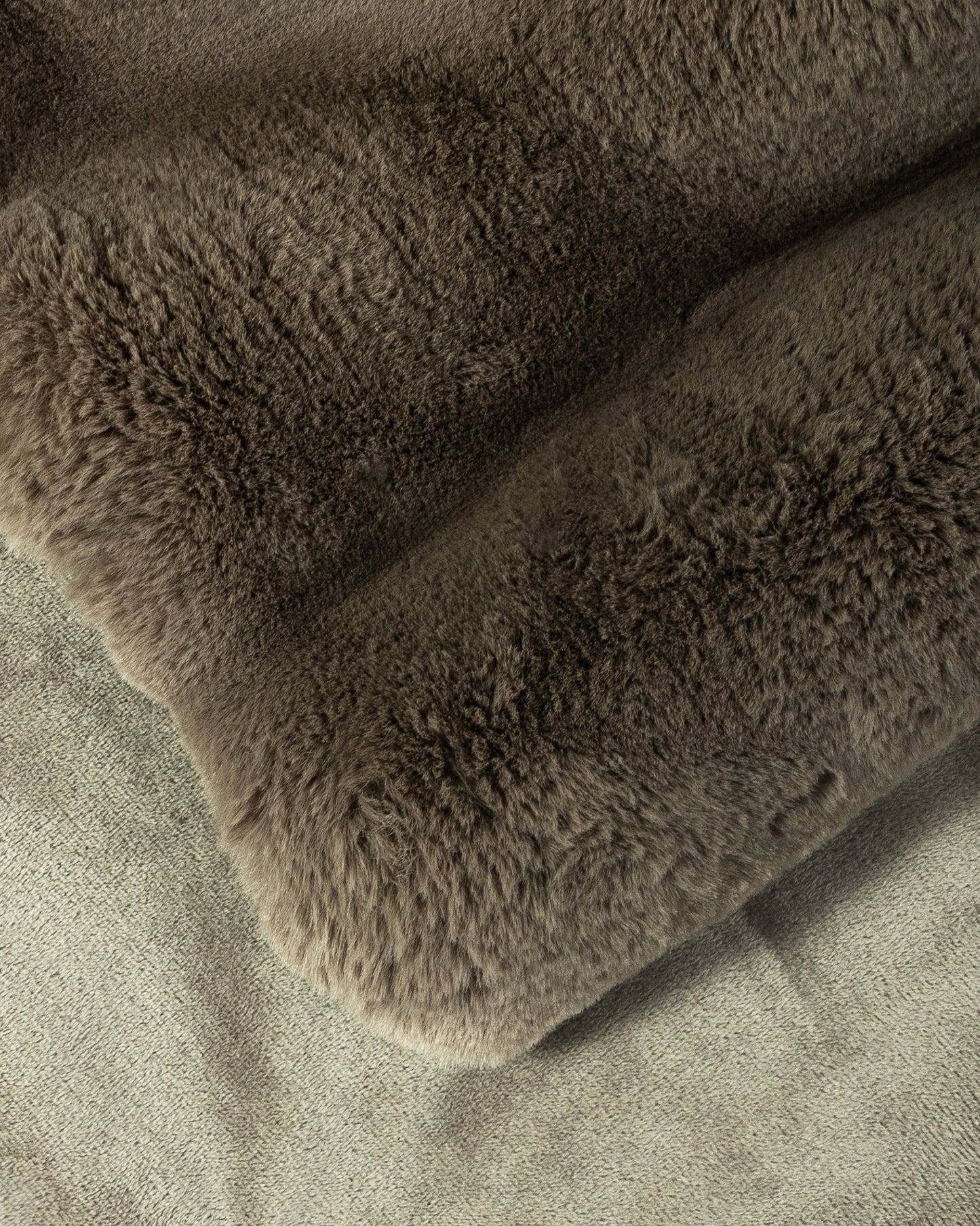close up fabric shot of a dimensional faux fur blanket in fungi