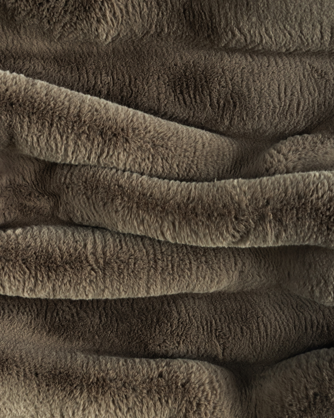 close up fabric shot of a dimensional faux fur blanket in fungi