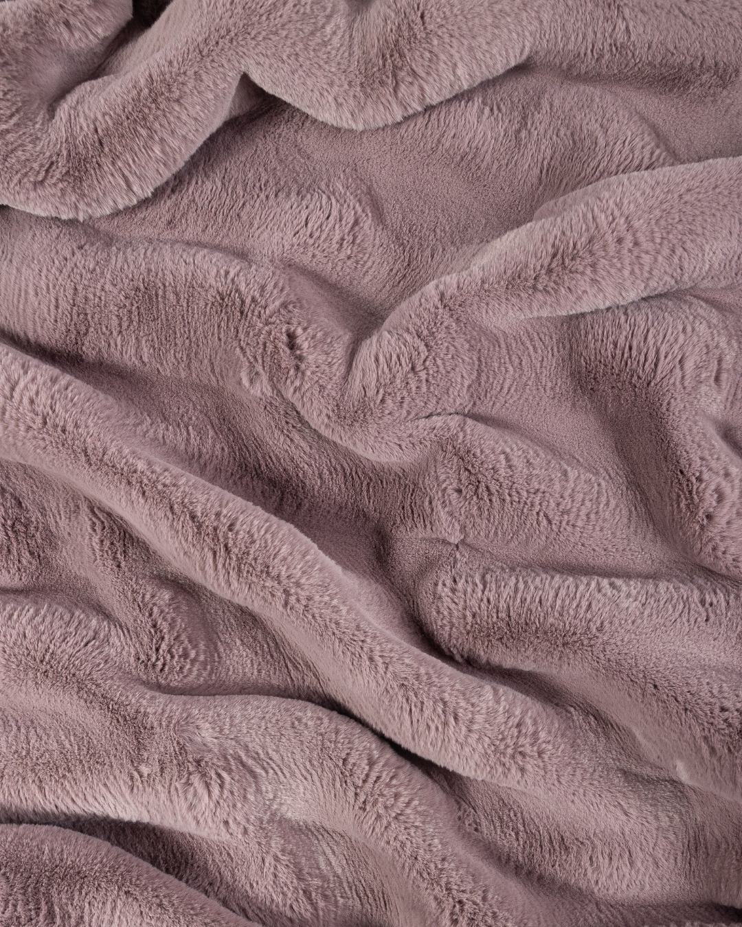 close up fabric shot of a dimensional faux fur blanket in lilac