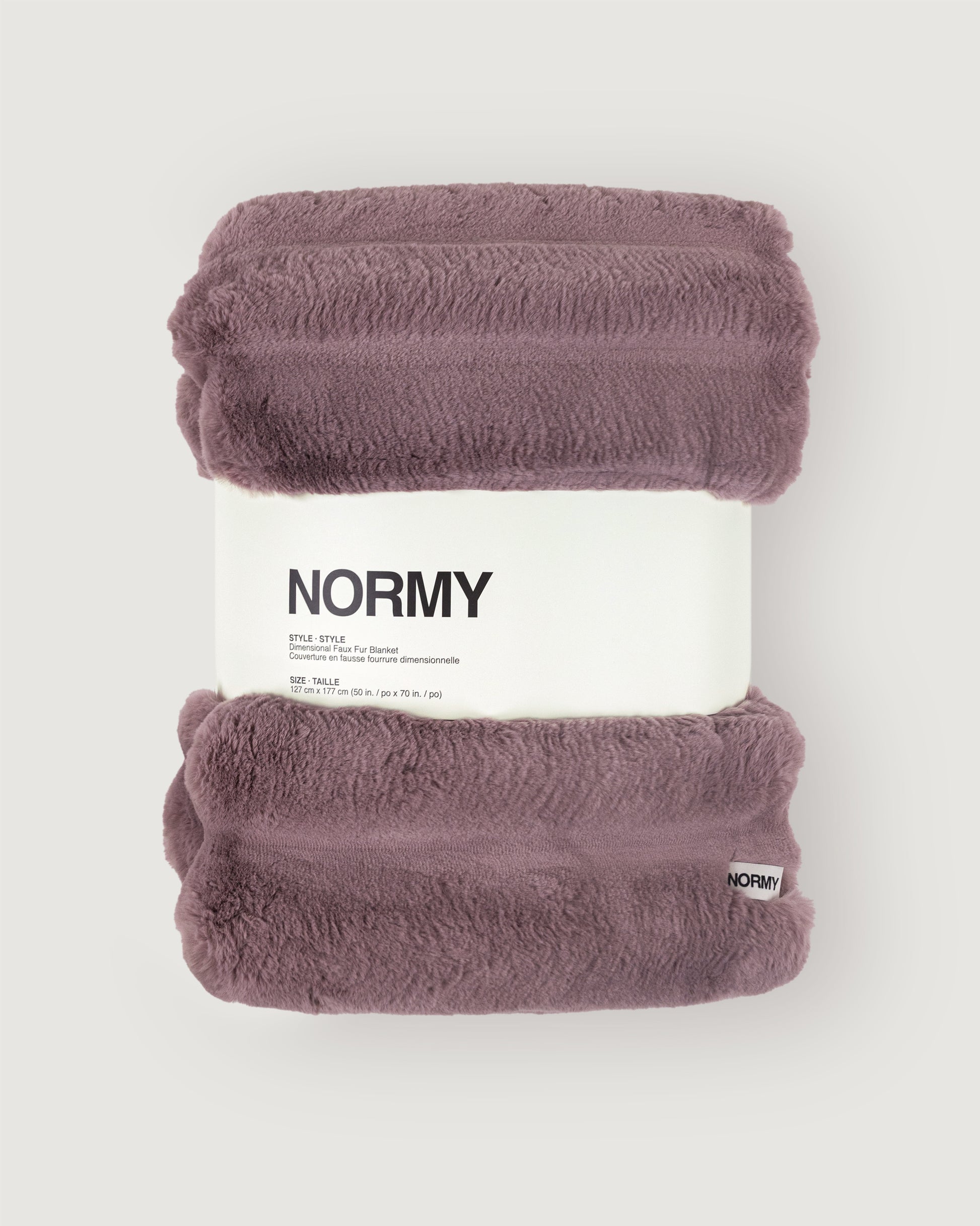 Dimensional faux fur blanket in lilac packaged in Normy packaging