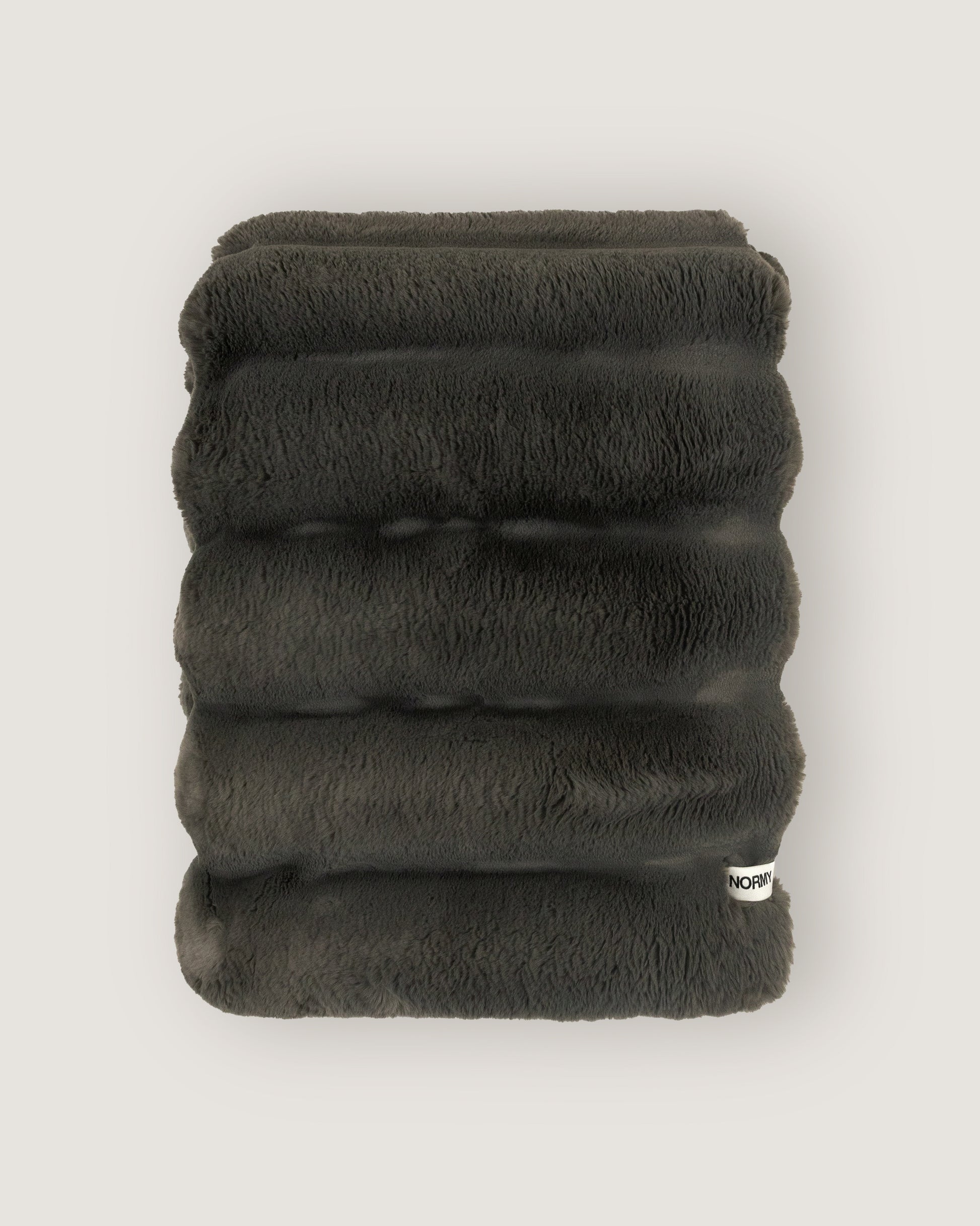 Dimensional faux fur blanket in peak folded against a neutral background