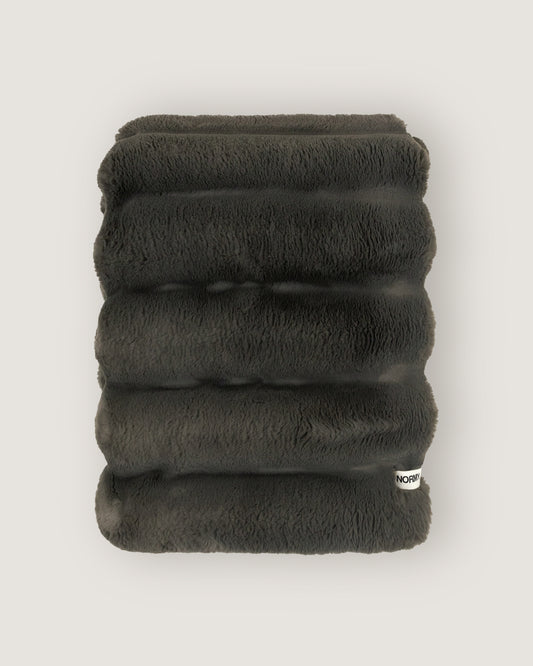 Dimensional faux fur blanket in peak folded against a neutral background