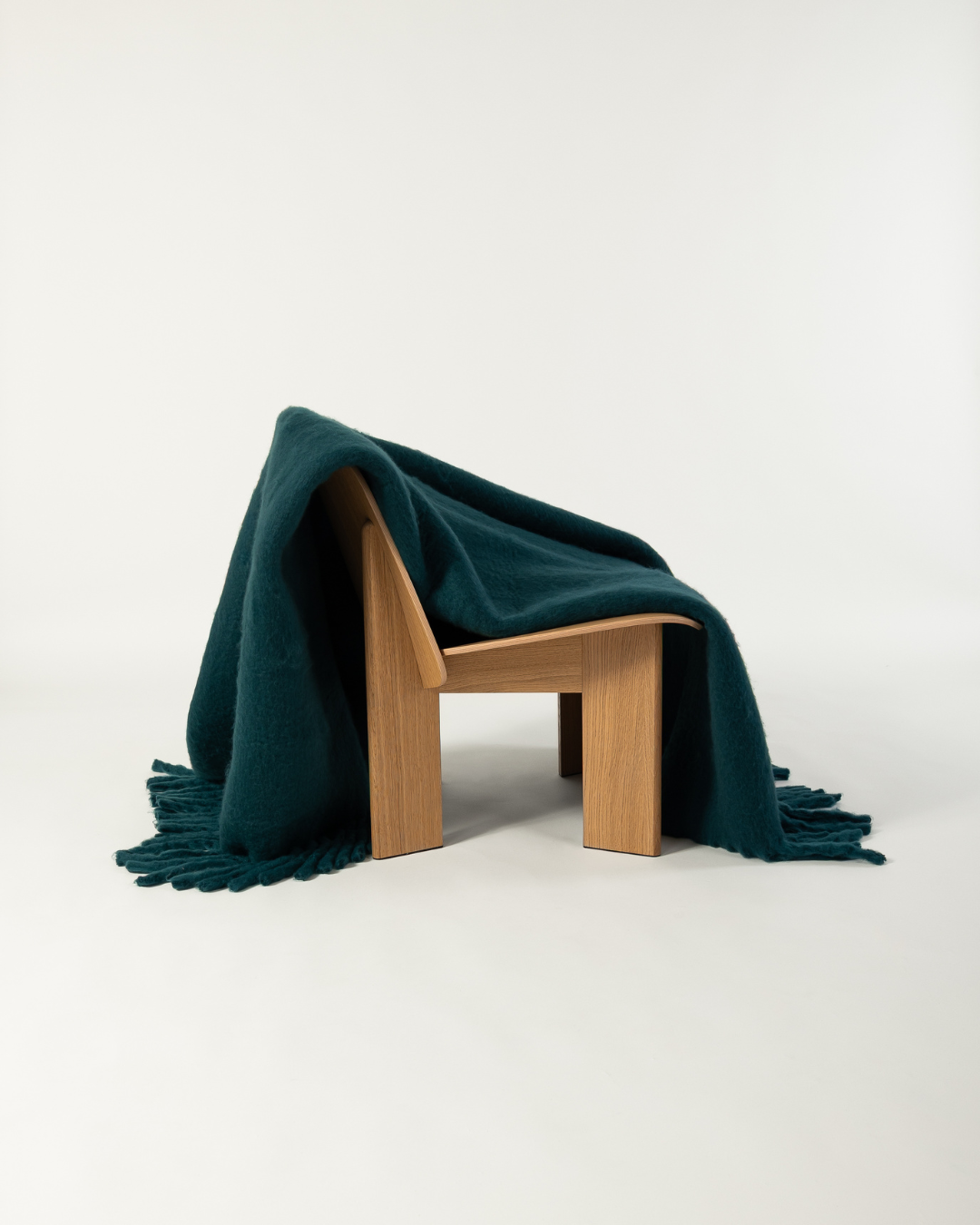 Faux mohair blanket in alpine draped over wooden chair