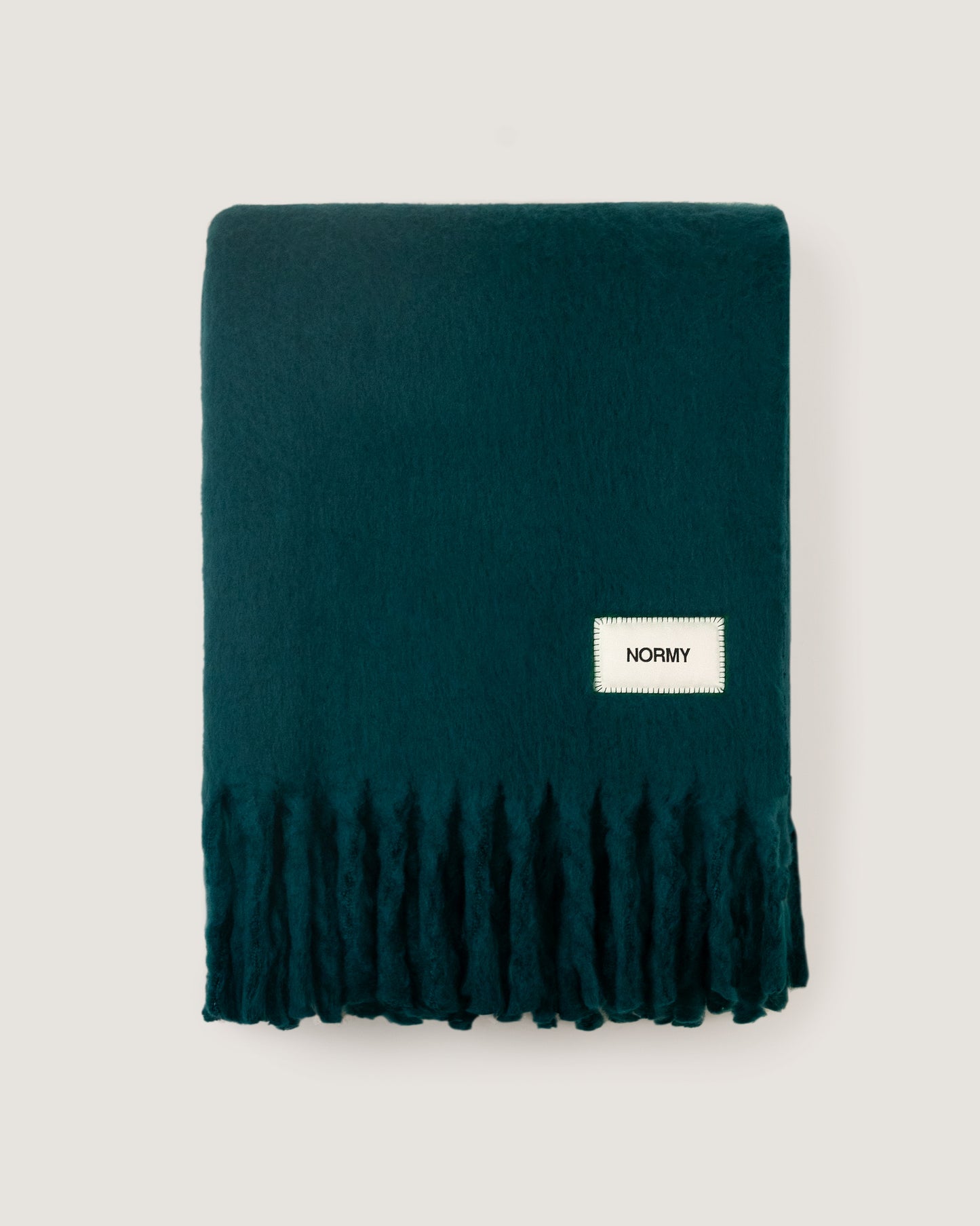 Faux mohair blanket in alpine folded against a neutral background