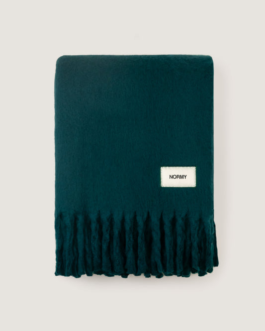 Faux mohair blanket in alpine folded against a neutral background