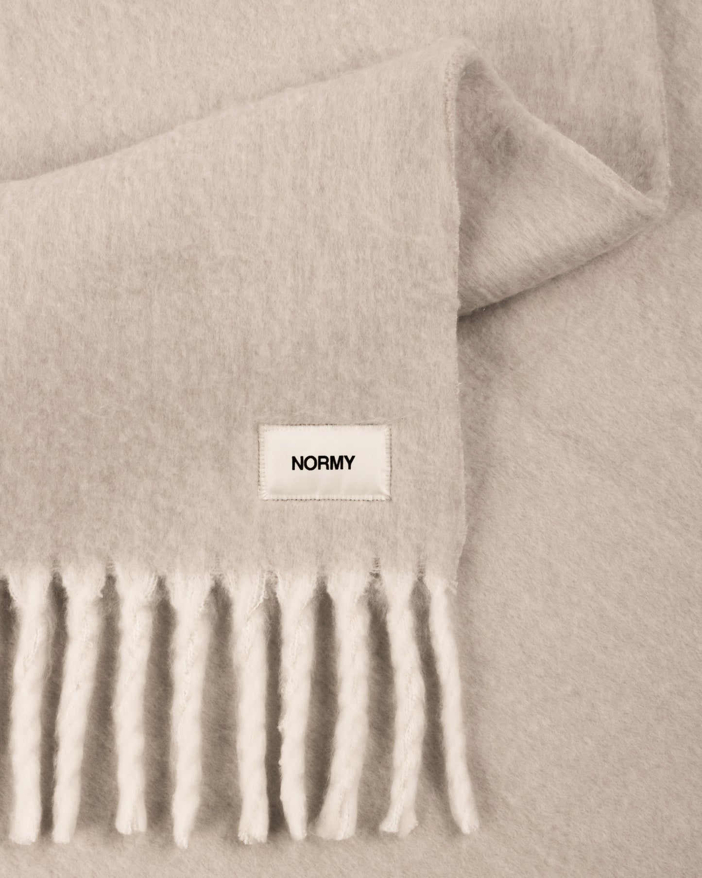Close up fabric shot of a faux mohair blanket in clay/moon