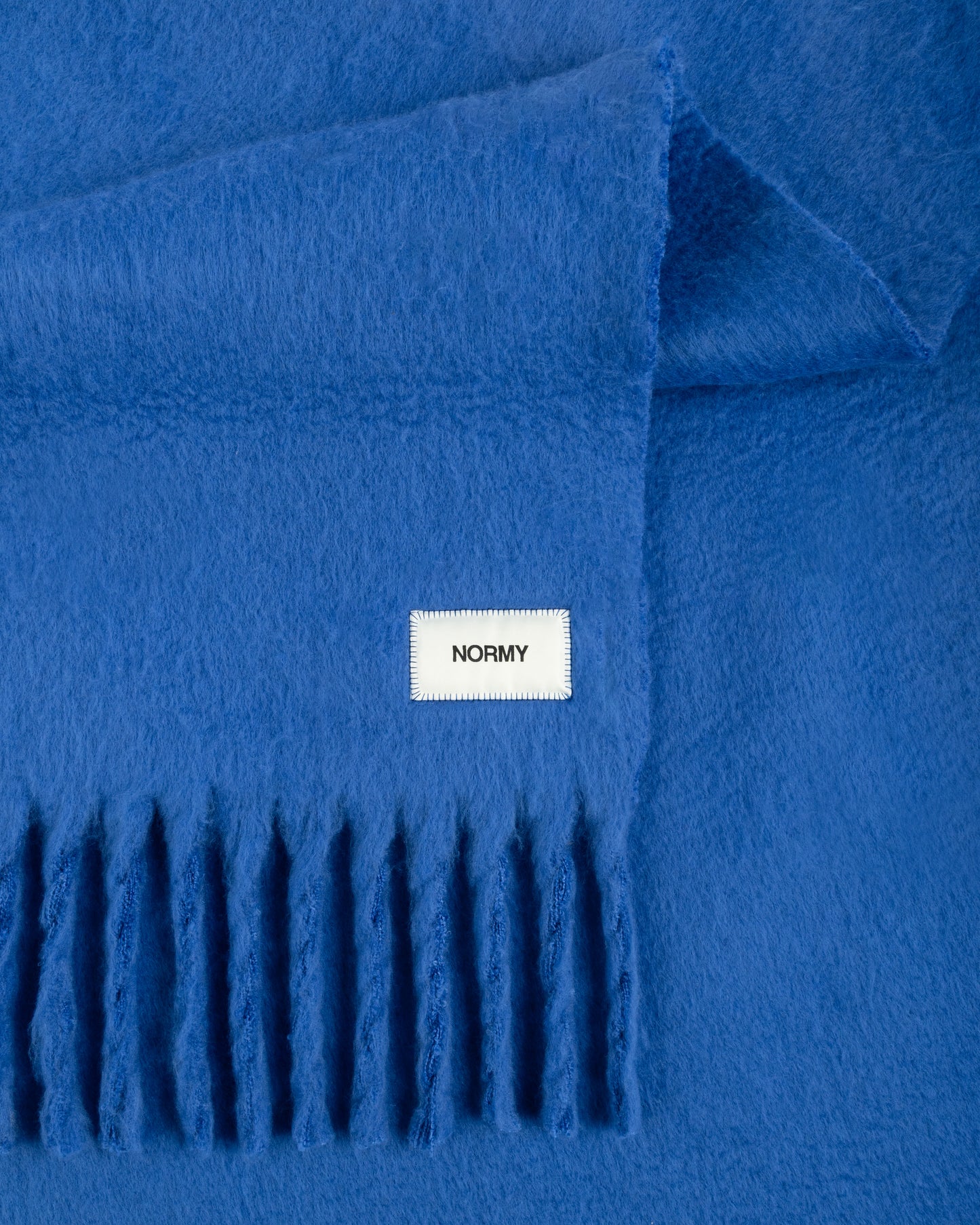 Close up fabric shot of a faux mohair blanket in cobalt 