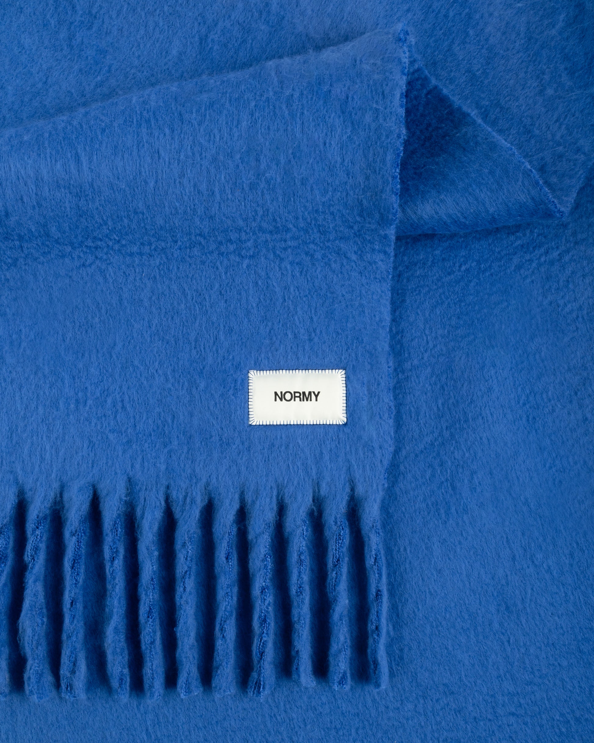 Close up fabric shot of a faux mohair blanket in cobalt 