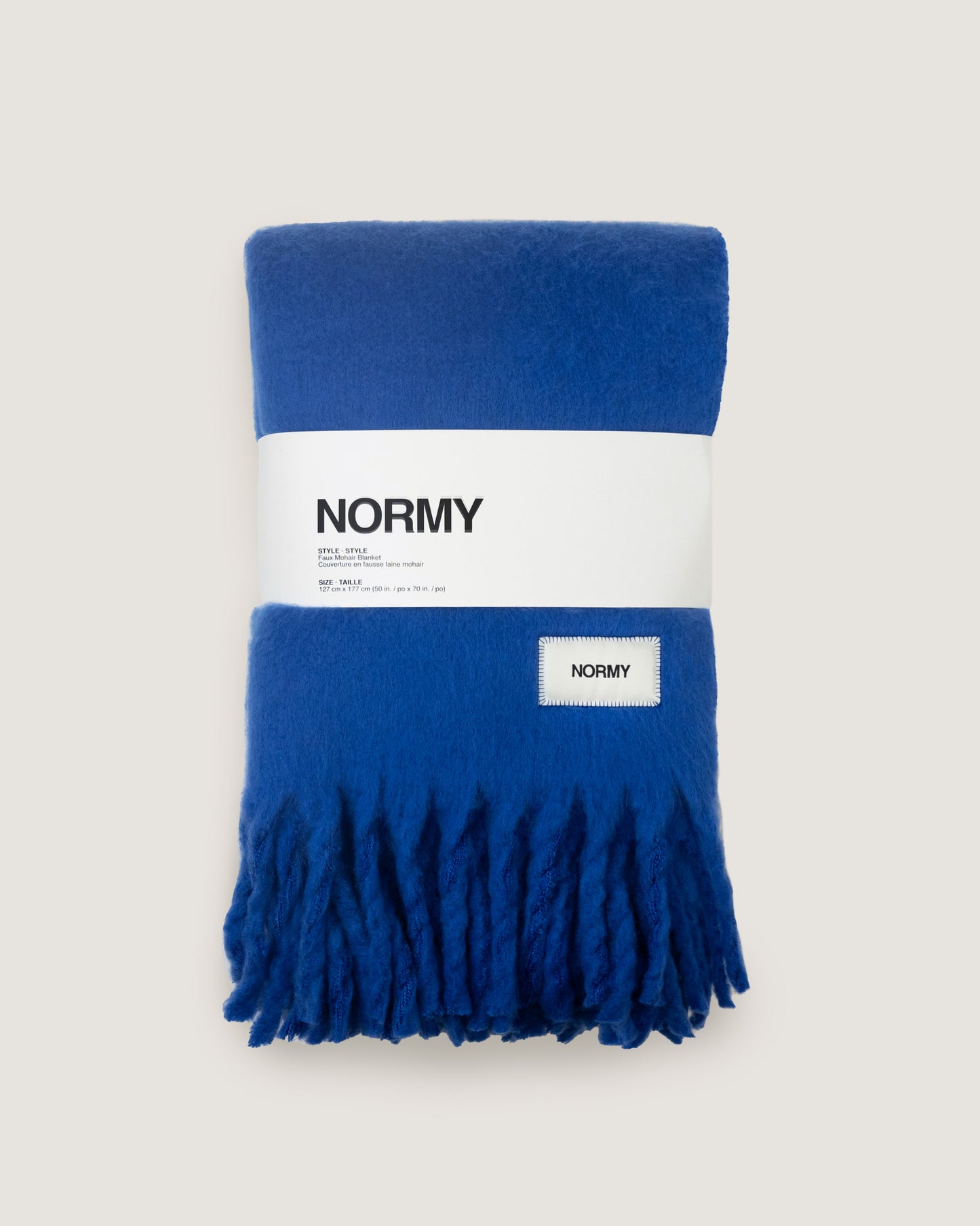 Faux mohair blanket in cobalt packaged in Normy packaging