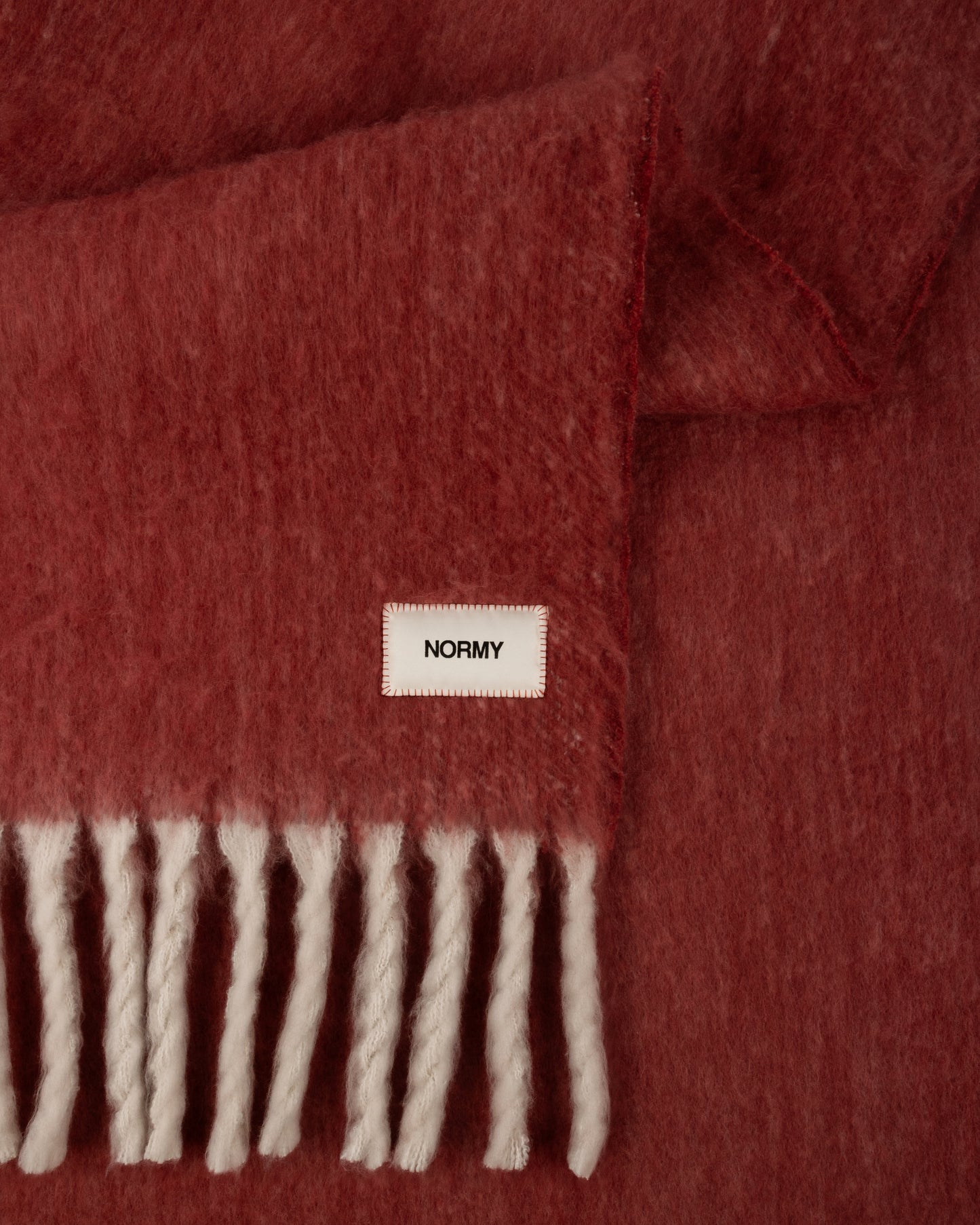 Close up fabric shot of a faux mohair blanket in pomegranate/moon
