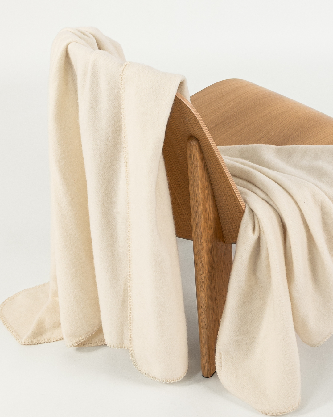 Merino wool blanket in moon draped over a wooden chair
