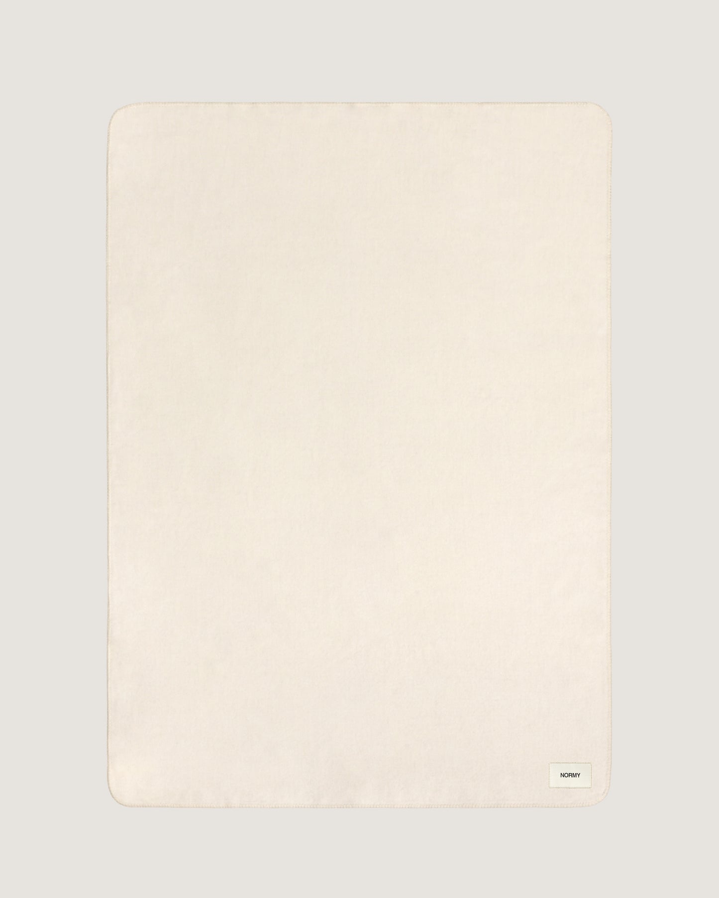 Merino wool blanket in moon flat against a neutral background