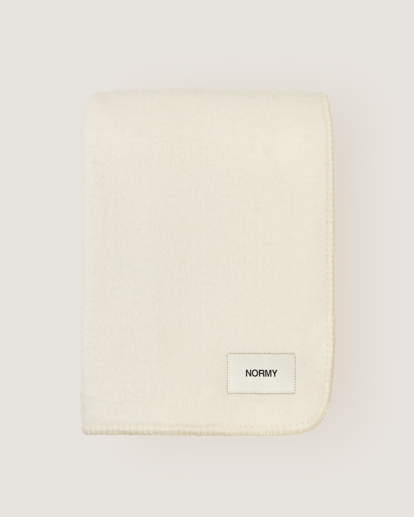 Merino wool blanket in moon folded against a neutral background