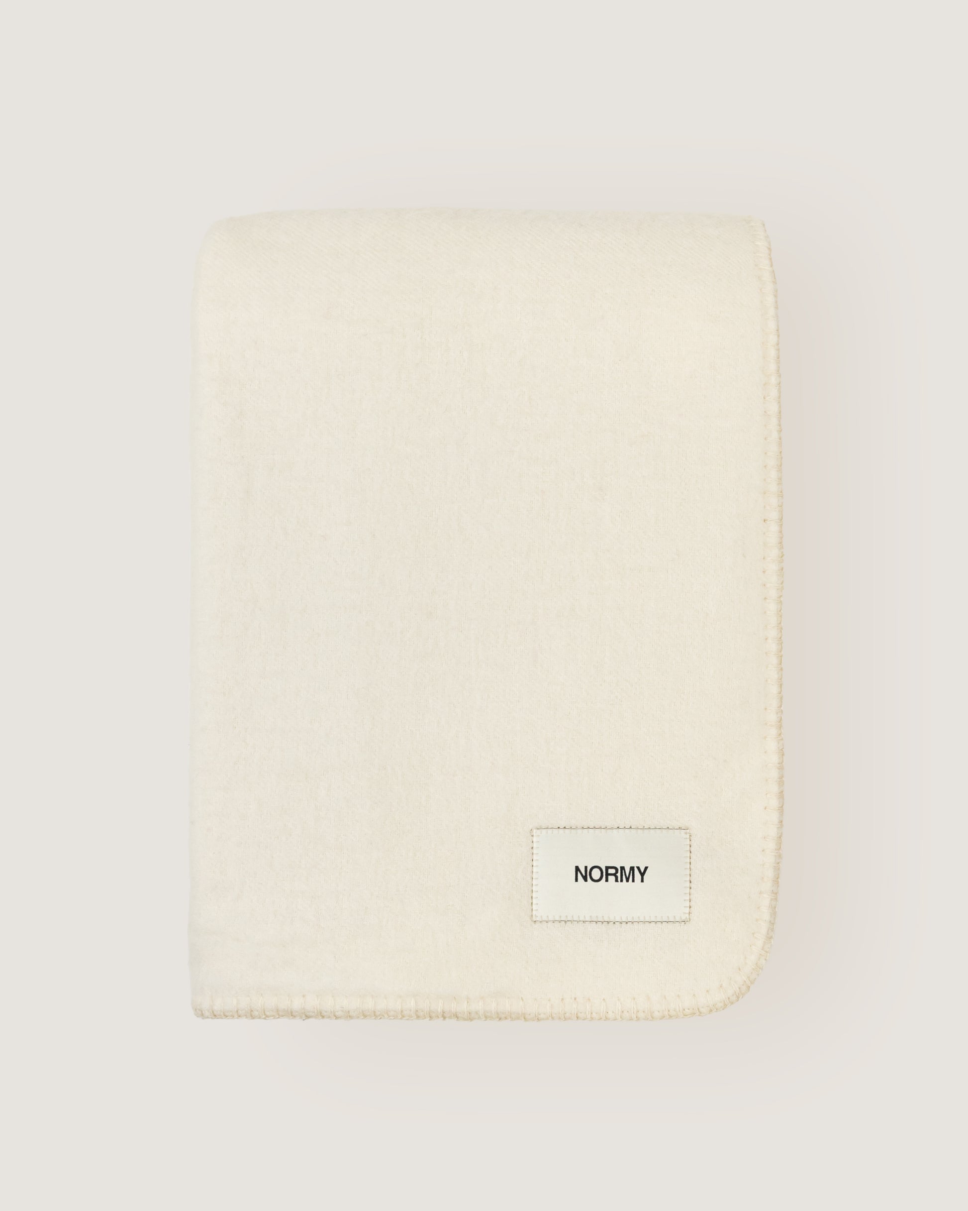 Merino wool blanket in moon folded against a neutral background