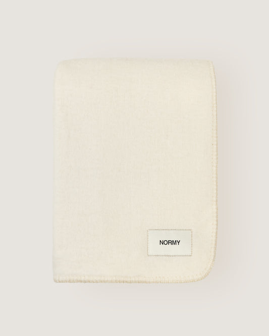 Merino wool blanket in moon folded against a neutral background