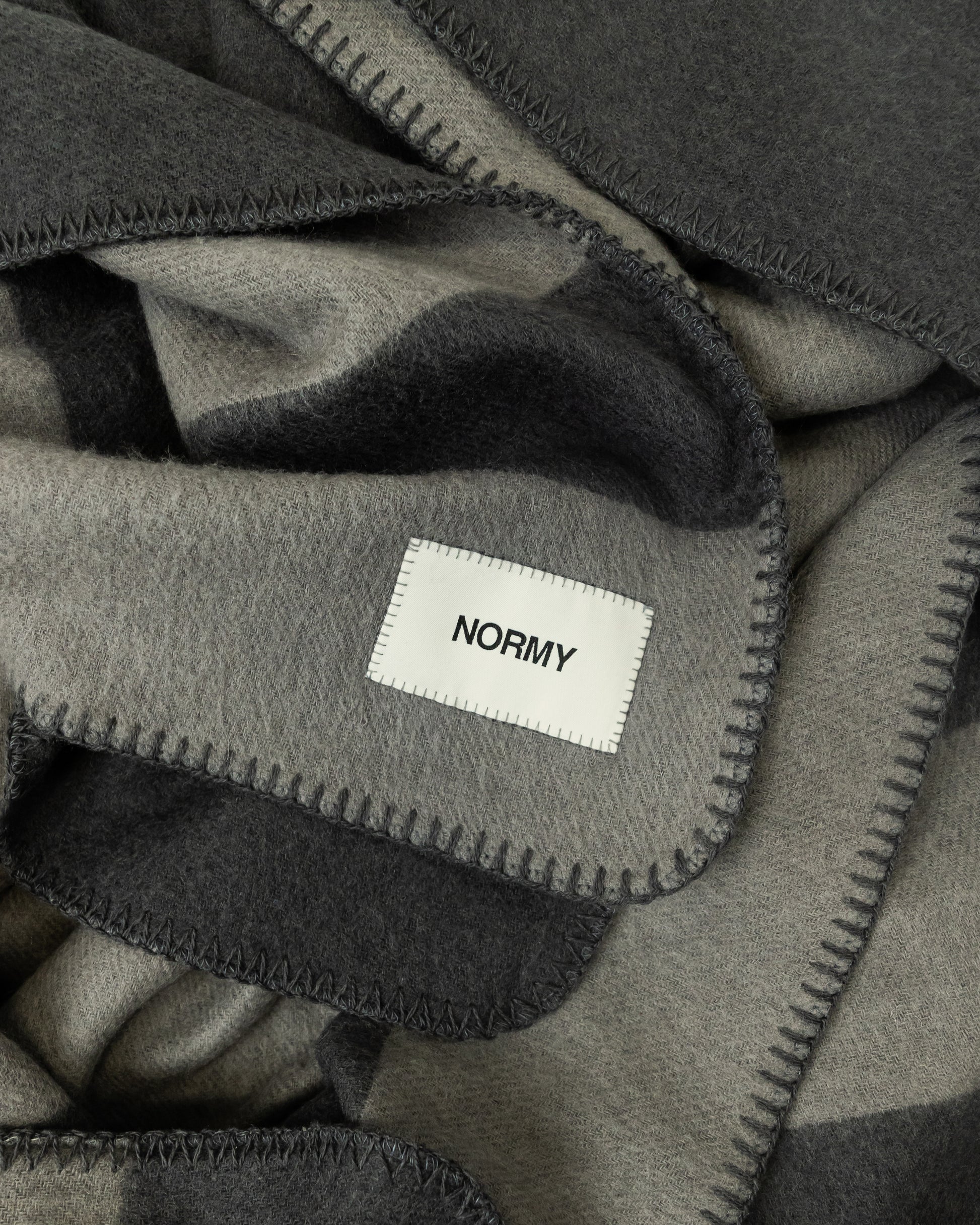 Close up fabric shot of a merino wool blanket in peak/caviar