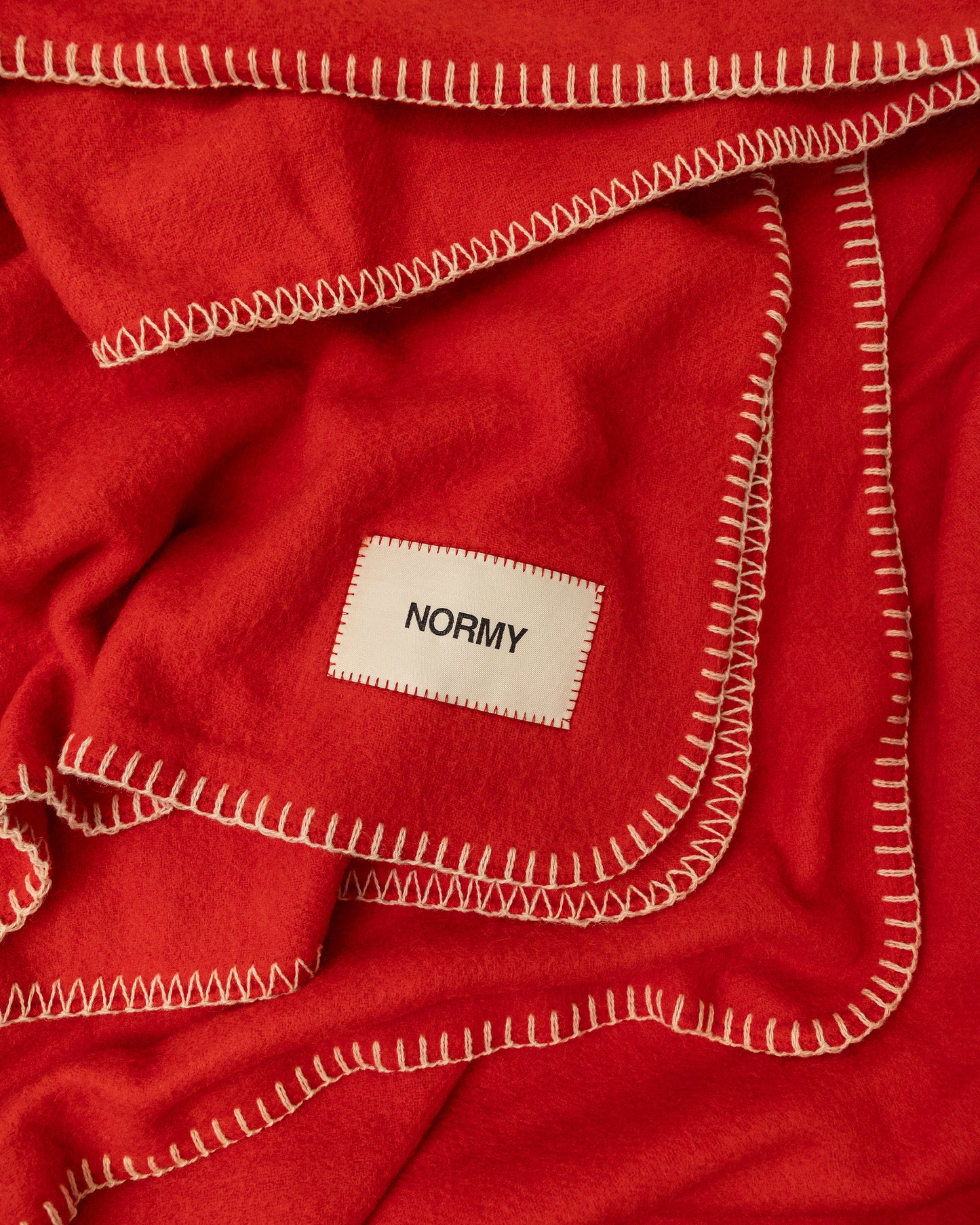 Close up fabric shot of a merino wool blanket in poppy