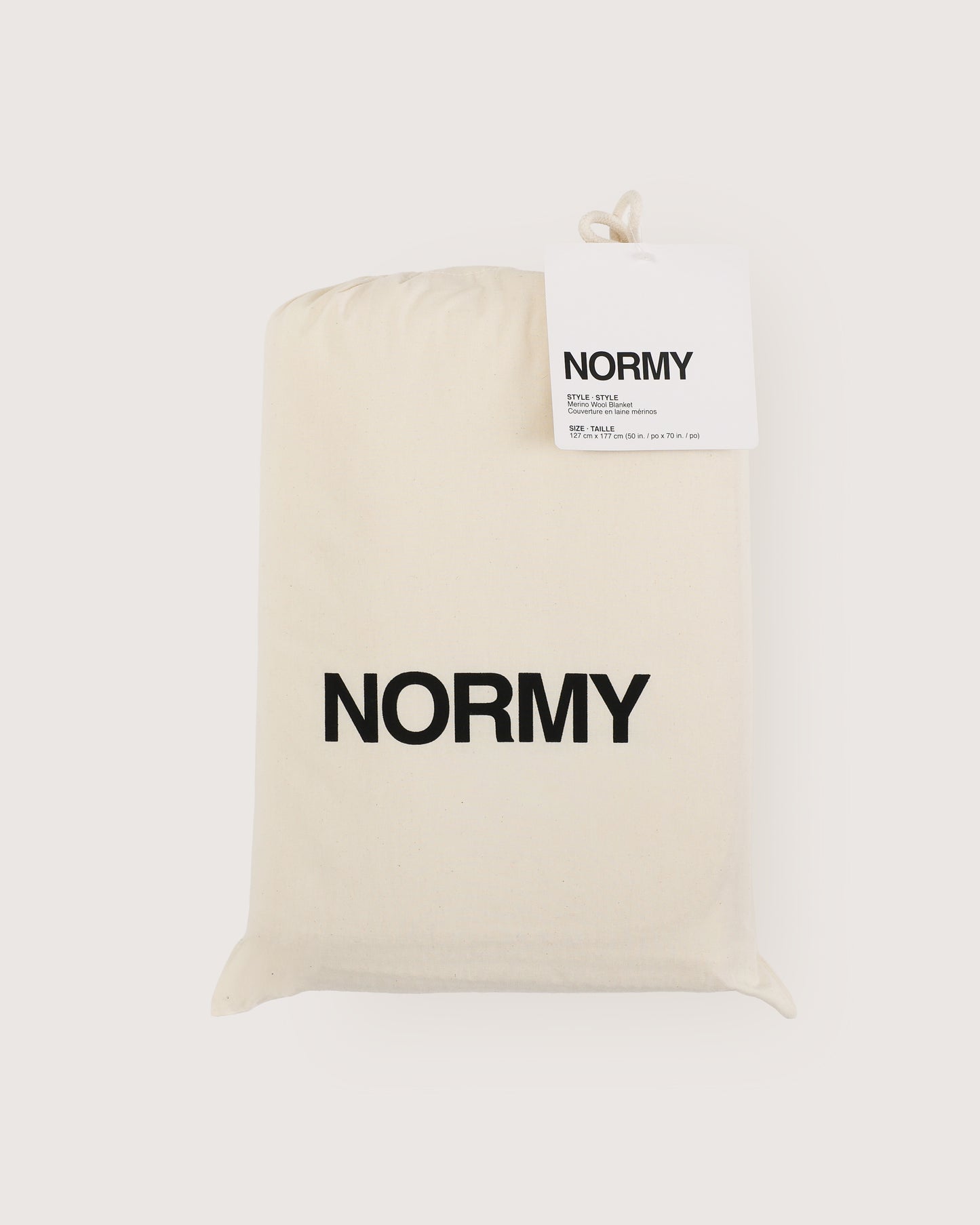 Merino wool blanket in poppy packaged in Normy packaging
