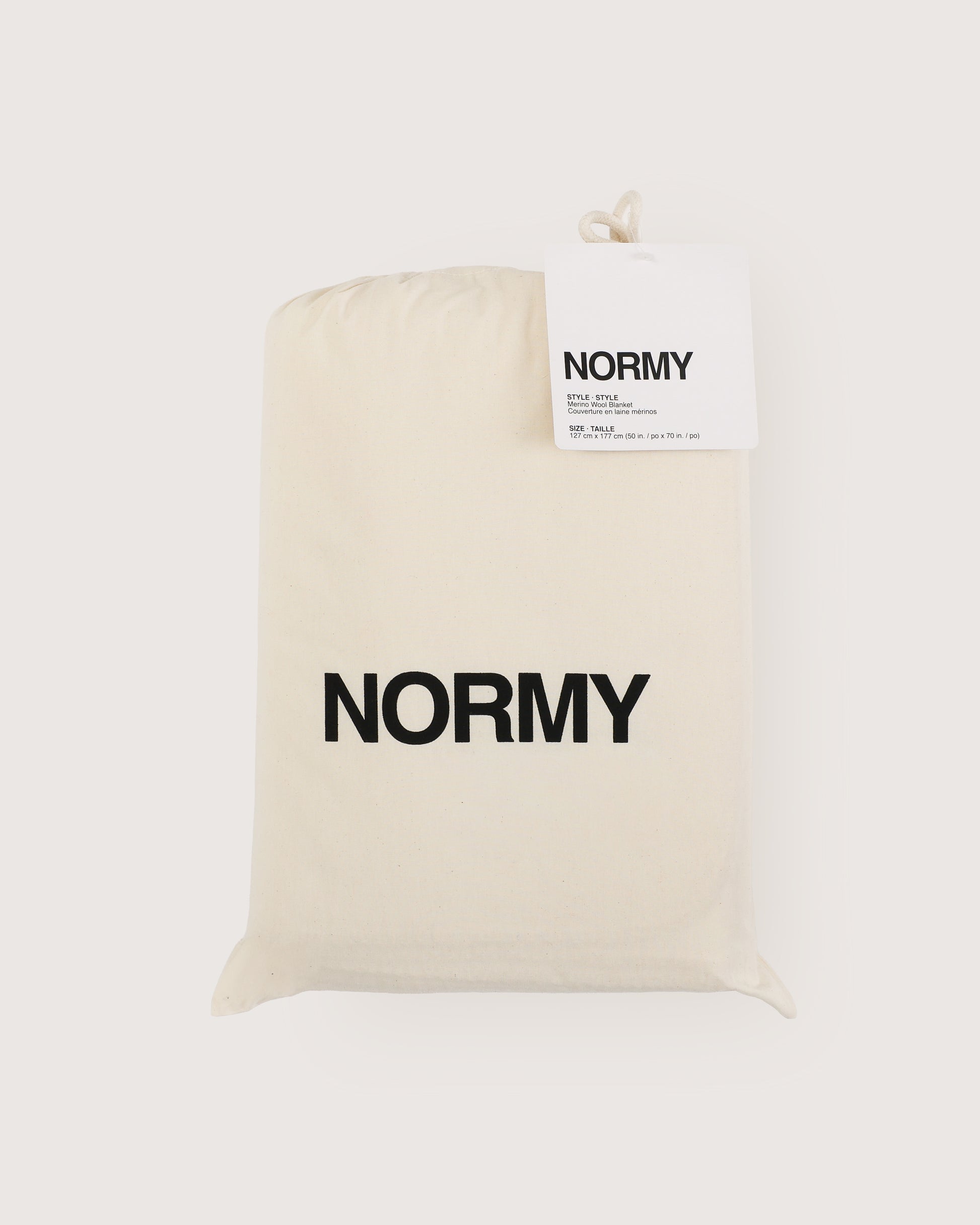 Merino wool blanket in poppy packaged in Normy packaging